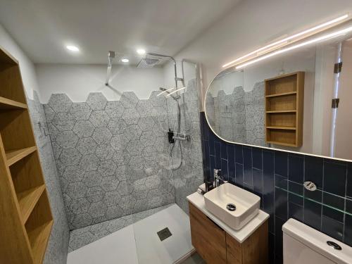 a bathroom with a shower and a sink and a mirror at Portus Noir Valletta in Valletta