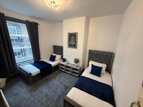 a hotel room with two beds and a window at ONYX Hotel Blackpool in Blackpool