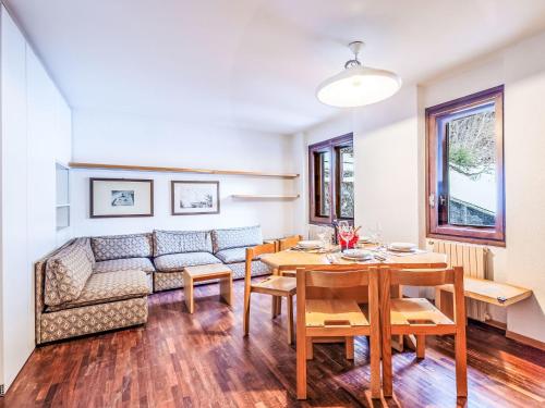 a living room with a table and a couch at Apartment Fondue by Interhome in Madesimo