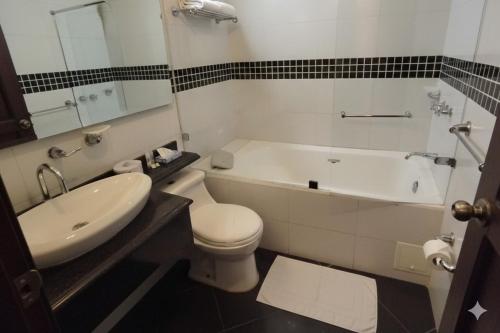 a bathroom with a tub and a toilet and a sink at Hotel Santamaria INN in La Ceja
