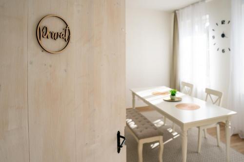 a white dining room with a white table and chairs at Atelier in Zvěrkovice