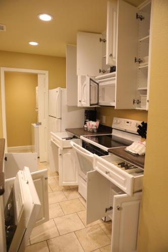 a kitchen with white cabinets and black counter tops at Unit at the Sheraton Broadway Plantation in Myrtle Beach