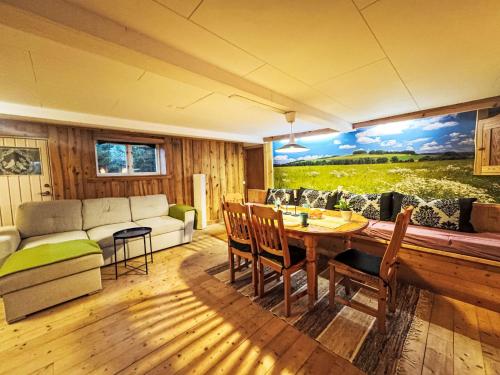 a living room with a couch and a table at Apartment Långerud by Interhome in Mellerud