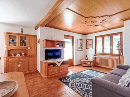 a living room with a couch and a tv at Apartment Casa Dalpi by Interhome in Predazzo