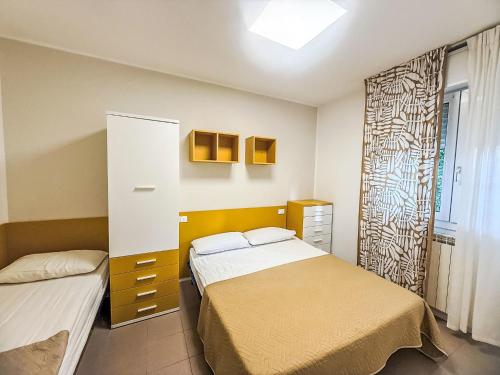 a bedroom with two beds and a window at Holiday Home Veranda-2 by Interhome in Rosapineta