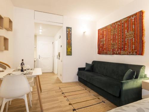 a living room with a green couch and a table at Studio Studio T by Interhome in Bormio