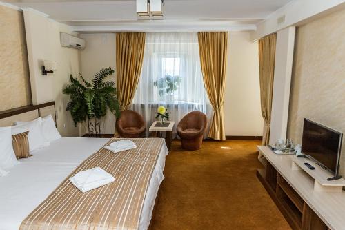 a hotel room with two beds and a flat screen tv at 7 Sky Hotel Klinicheskaya Street (2d entrance) in Kyiv