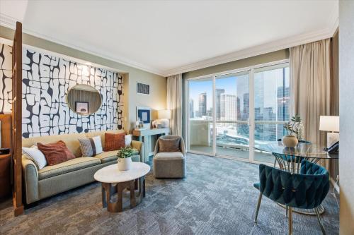 a living room with a couch and a large window at Stunning Balcony Strip View MGM Signature * Free Valet in Las Vegas