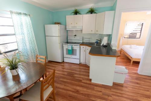 a kitchen and dining room with a table and a dining room at Cindy Villa in Key Largo