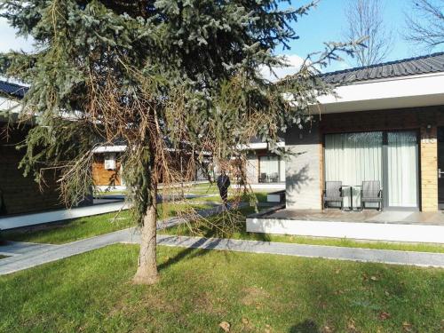 a tree in the yard of a house at Villas and apartments Oaza in Sarajevo