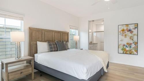 a white bedroom with a large bed and a window at Summerwell by AvantStay in La Quinta