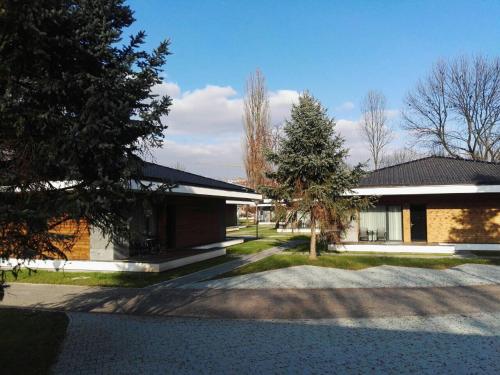 a brick building with a tree in front of it at Villas and apartments Oaza in Sarajevo