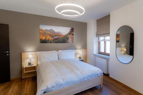 a bedroom with a large bed and a mirror at Casa vacanza Garcia in Paluzza