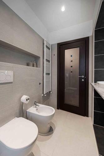 a bathroom with a white toilet and a sink at Casa vacanza Garcia in Paluzza