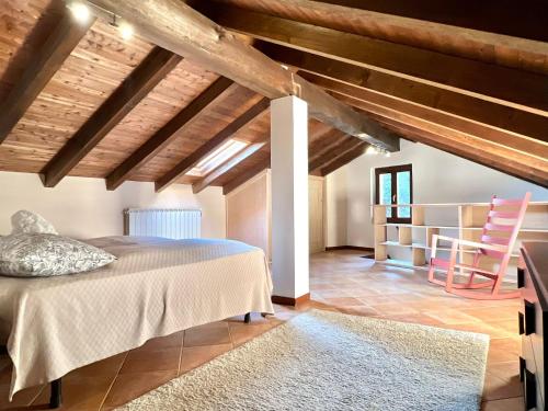 a bedroom with a bed in a room with wooden ceilings at Casa Bùri in Trarego