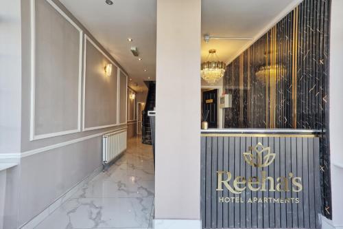 a lobby of a hotel with a sign on the wall at Reeha's Hotel Apartments in Southend-on-Sea