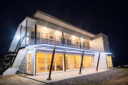 a white building with lights on it at night at Belechl Ranch Studio Rental - Cozy Compact Room with Private Bathroom in Koror