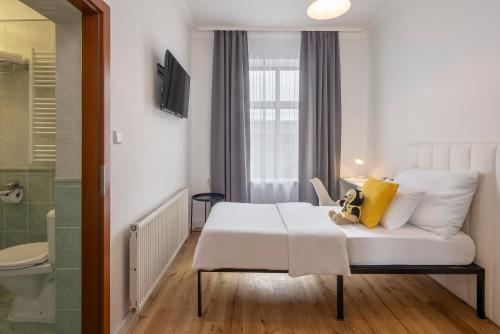 a hotel room with a bed and a bathroom at Pytloun Self Check-in Hotel Liberec in Liberec
