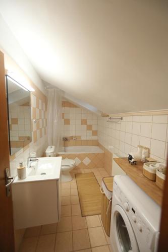 a bathroom with a sink and a washing machine at Lacus Orestias - unlimited view in Kastoria