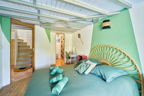 a bedroom with a large bed with blue pillows at Ker Berthe - Maison spacieuse - lumineuse - 4 chambres in Cesson-Sévigné