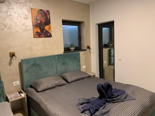 a bedroom with a bed with a towel on it at PARAVANHouse in Constanţa