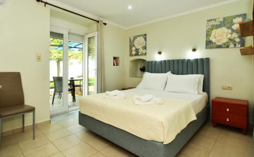 a bedroom with a bed with two towels on it at Studios Avra in Skala Rachoniou