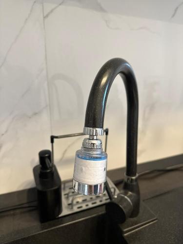 a kitchen sink with a faucet on a counter at Noblesse residence - parking Militari residence Chiajna Dudu in Chiajna