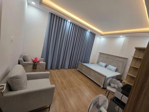 a small living room with a bed and a couch at Đức Khoa Villa Phu Quoc in Phú Quốc