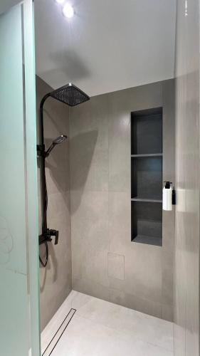 a shower with a shower head in a bathroom at Shams Boutique Hotel in Bukhara