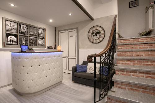 a living room with a staircase and a stair case at Residenza Centro Storico in Lucca