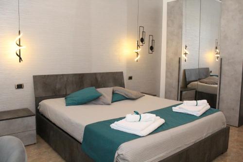 a bedroom with a bed with towels on it at Luca's House - Villa sul mare con piscina in Giovinazzo