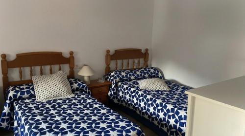 two beds sitting next to each other in a room at Casa Bueu Pontevedra in Bueu