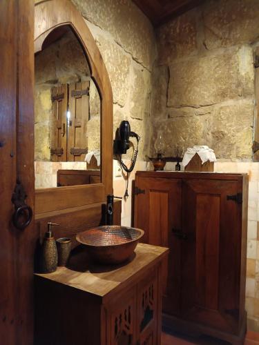 a bathroom with a wooden sink and a mirror at Castelo de Portugraal in Vilela