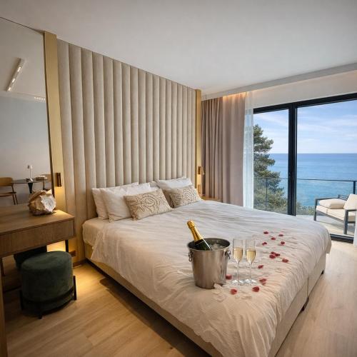 a bedroom with a bed with wine glasses on it at Apartament 330 Przy Plaży, parking gratis! in Międzyzdroje