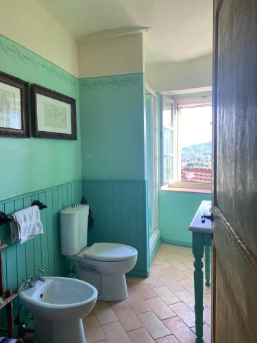 a bathroom with a white toilet and a sink at Casa Rosmarino Malgrate in Filetto