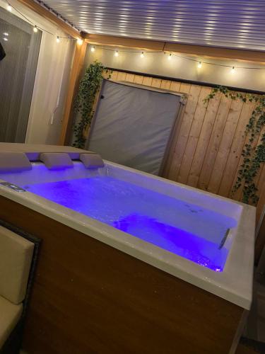 a large tub with blue water in a room at Sweet Loft Maglie in Maglie