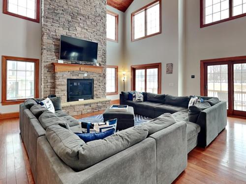 a large living room with couches and a fireplace at Limitless Joy in Swanton