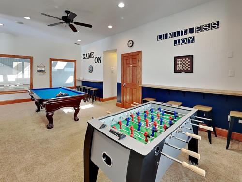 a living room with a pool table and a ceiling fan at Limitless Joy in Swanton