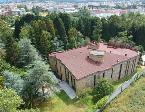 an aerial view of an old building with a red roof at AG Casa O Remanso de Pedreira con finca 20000 m2 in Carballo