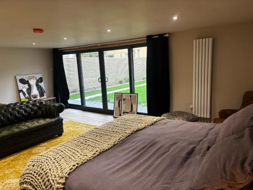 a bedroom with a large bed and a large window at The Cabin in St. Ives
