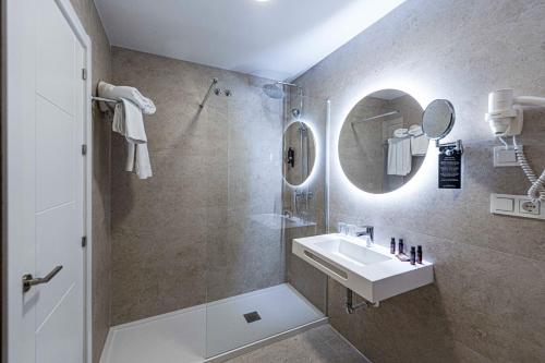 a bathroom with a sink and a shower at Hotel Puerta del Mar - Adults Recommended in Nerja