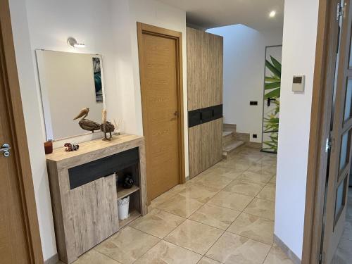 a hallway with a fireplace and a mirror at 32 Salamandre in Les tres Cales