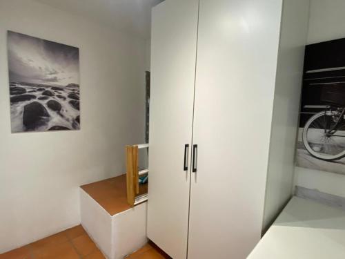 a room with a white cabinet and a picture at Seaview in Hout Bay
