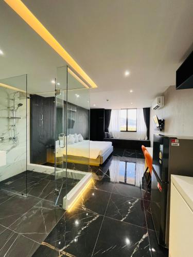a bedroom with a bed and a glass shower at Stylish Condo Near Nai Harn Beach Full Facilities Utopia M720 in Rawai Beach