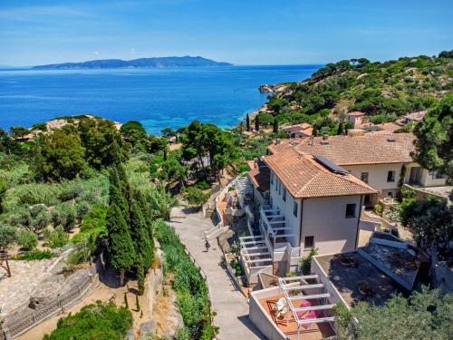 an aerial view of a house and the ocean at Hotel L'Arenella in Giglio Porto