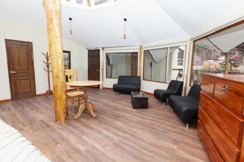 a room with a bed and a table and chairs at Caisae Eco-Lodge in San Antonio