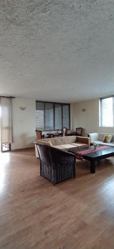 a large living room with a large couch and a table at Kings Home Stay in Nakuru