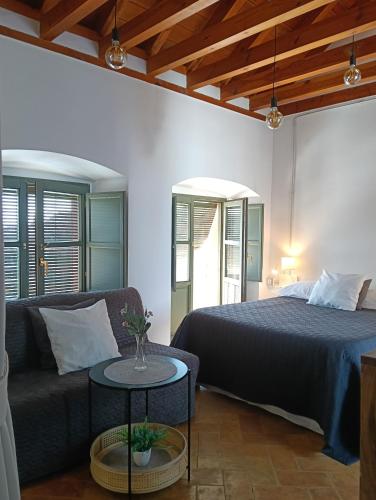 a bedroom with a bed and a couch and a table at Corredera Travel 5 in Córdoba