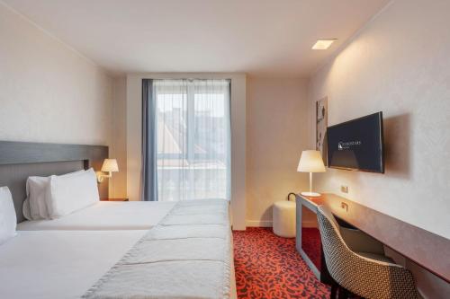 a hotel room with a bed and a window at Eurostars Palazzo Zichy in Budapest