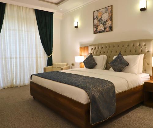 a hotel room with a large bed and a window at Anbar International Hotel in Kumaysh